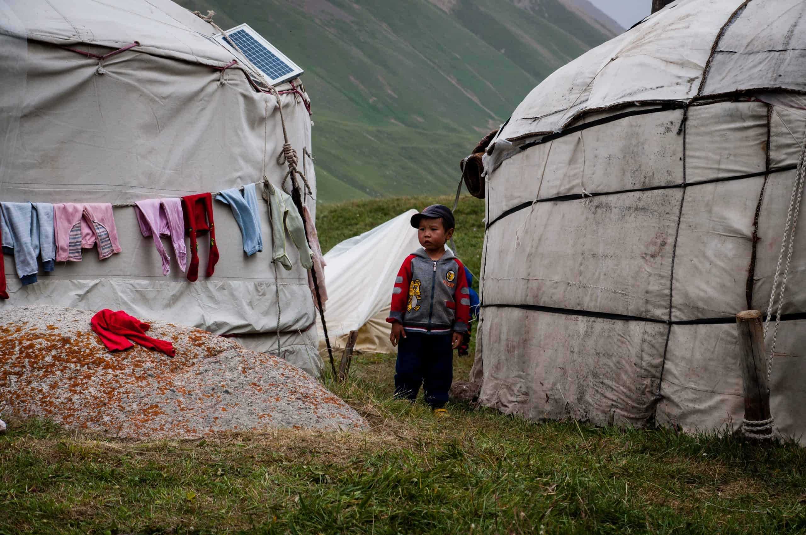 Boy outside of tents with laundry hung in Kyrgyz Republic