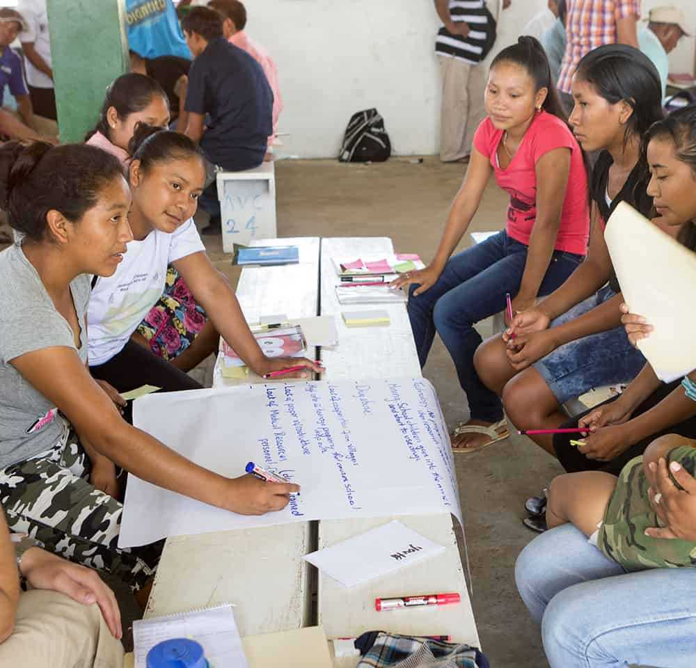 Group of people writing in Guyana