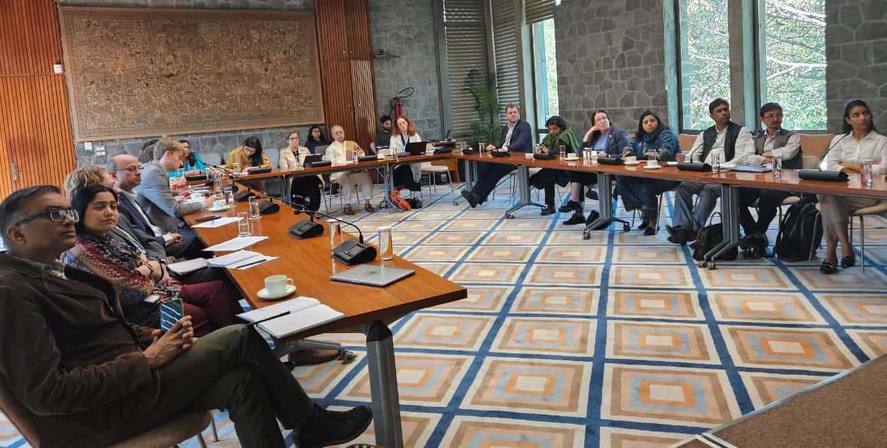 A group of people sitting at a table at the PAGE India partners meeting