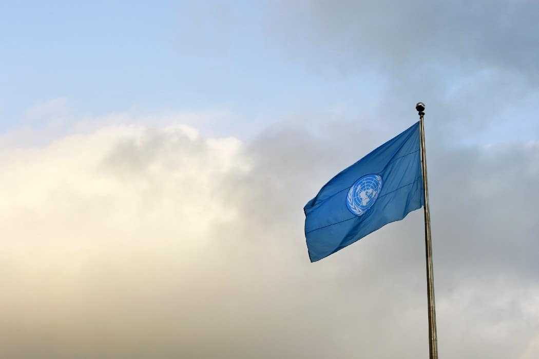 A blue United Nations flag on a pole