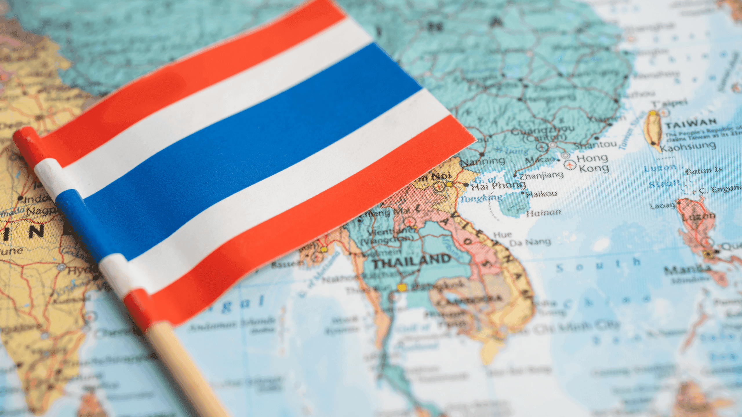 A flag of Thailand on a map of Thailand