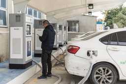 Man electrically charging car