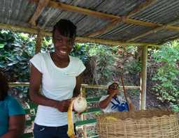 Woman named Kaywana shaving fruit at a stand in Barbados