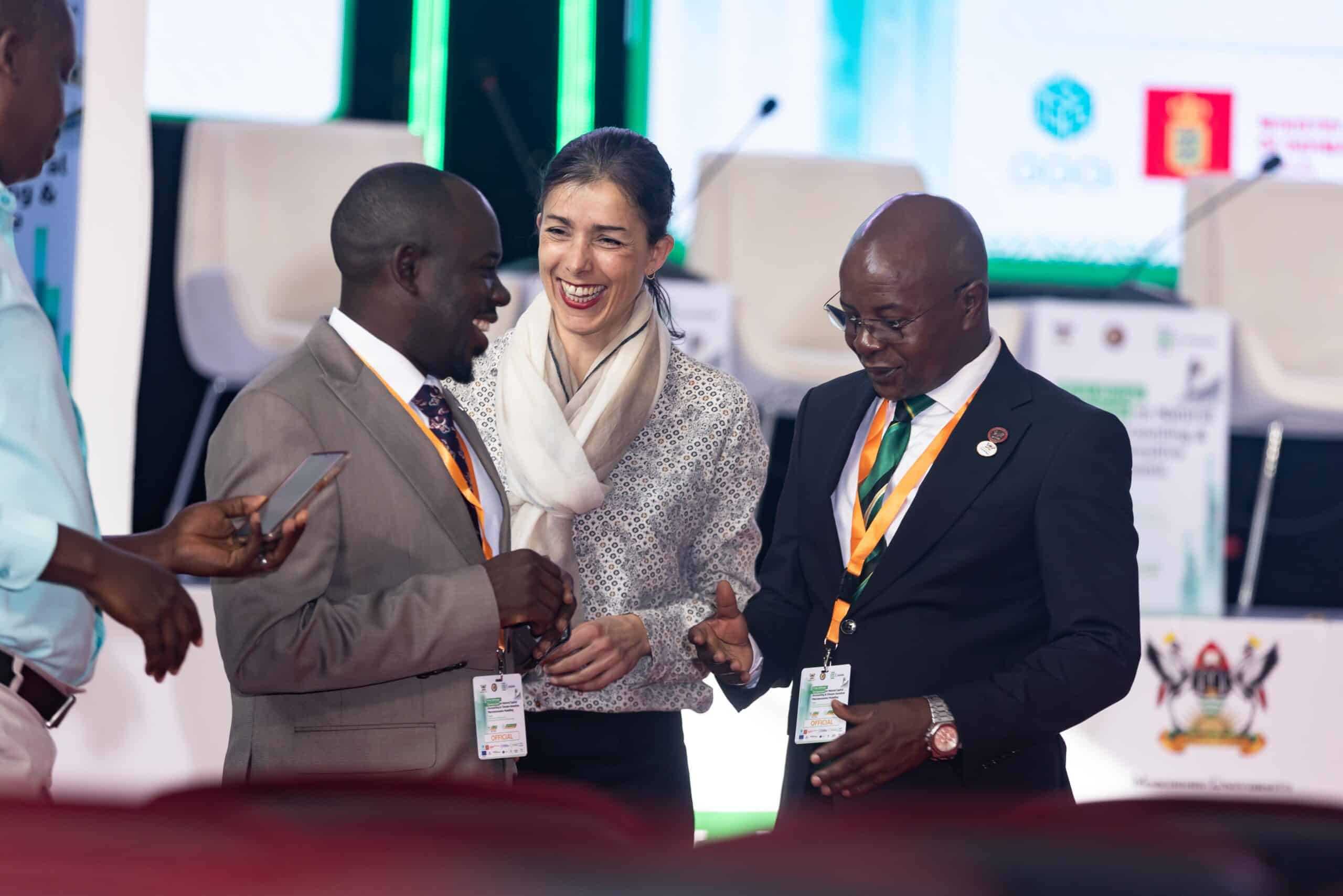 Officials exchanging greetings at the Makerere Symposium