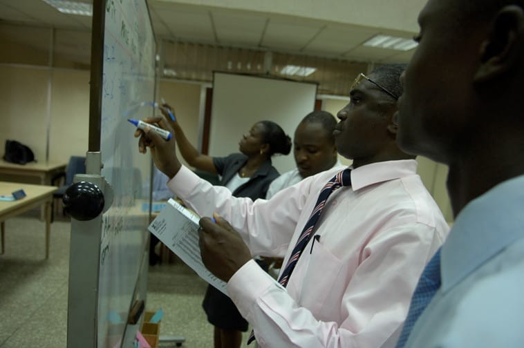 Staff writing on whiteboard