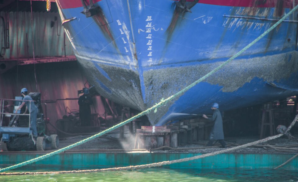 Man cleaning ship