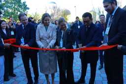 A group of people cutting a red ribbon at the Bishkek Green Economy Forum 2023.