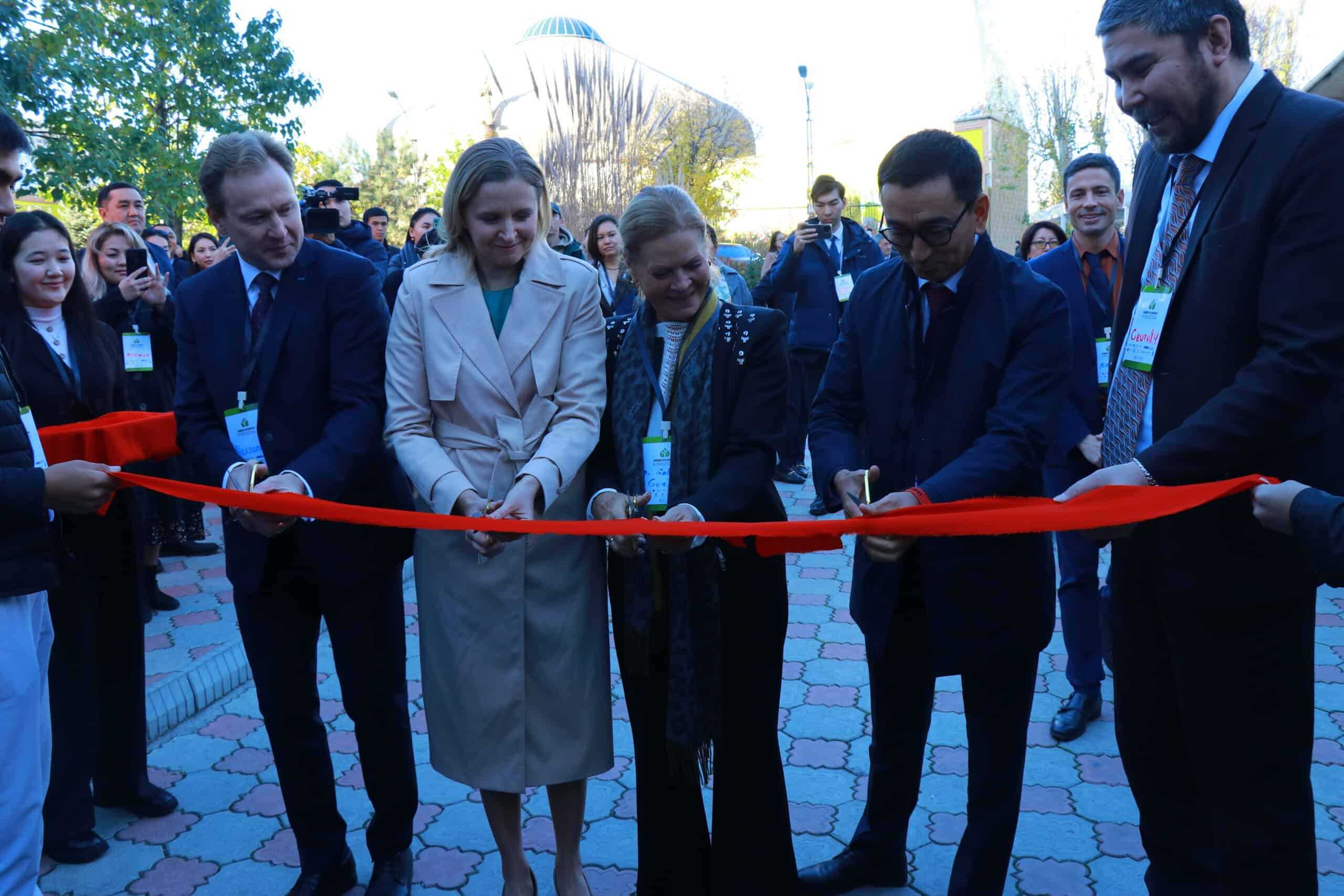 A group of people cutting a red ribbon at the Bishkek Green Economy Forum 2023.