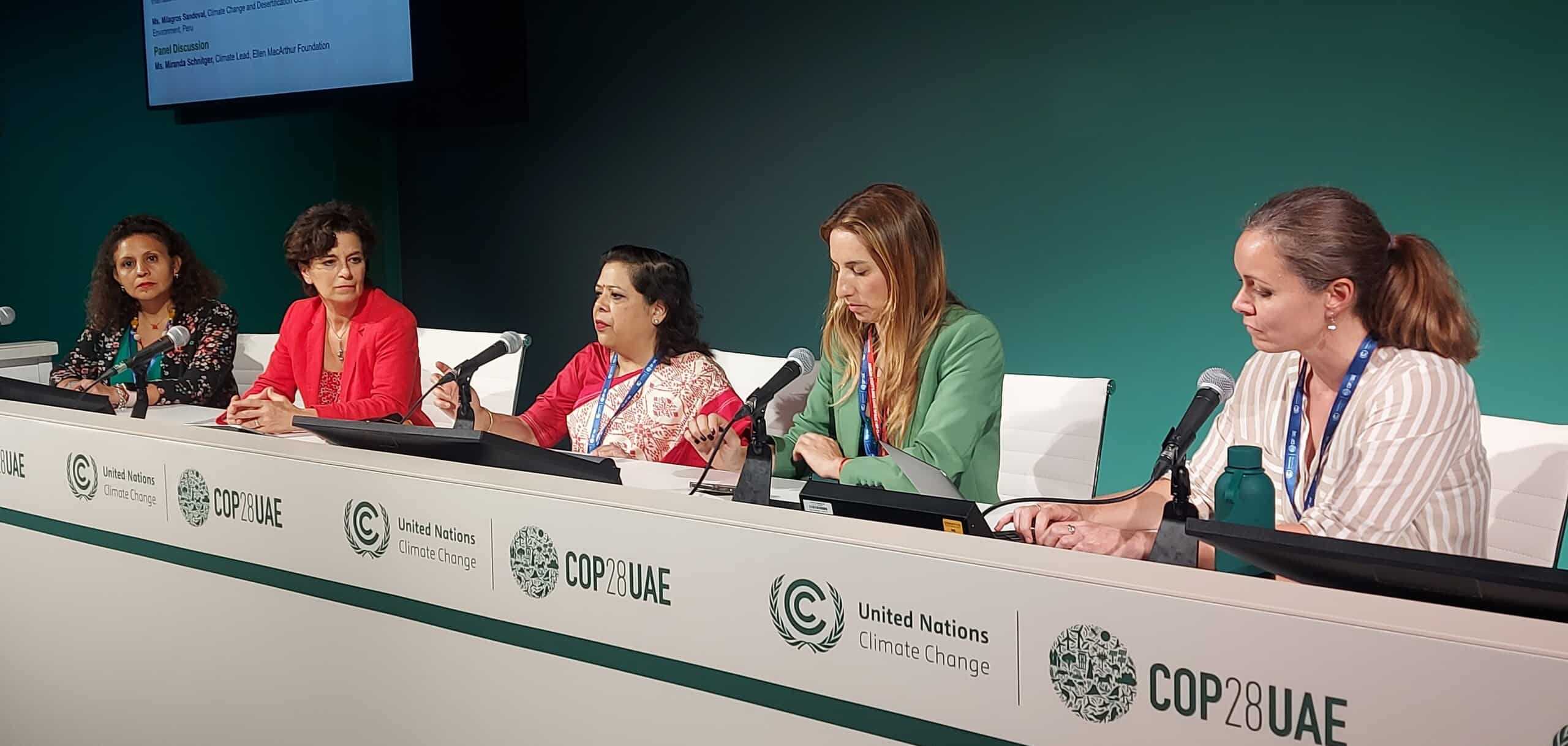 All-female panelists sitting at the podium during COP28 for a discussion on circularity.