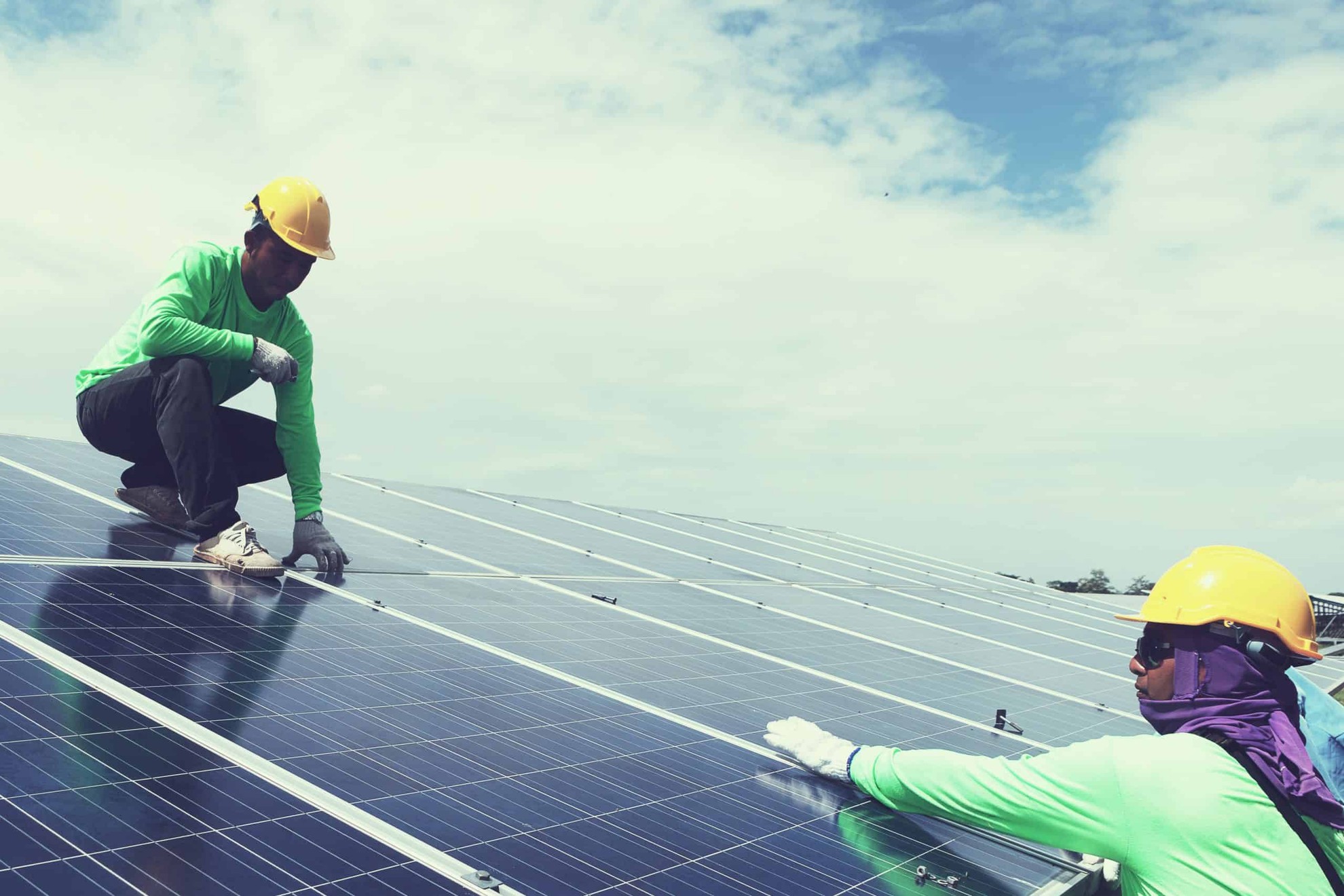 Men working on solar panels