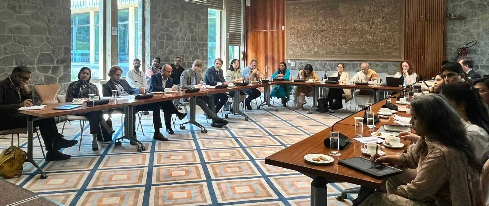 A group of people sitting at tables in a room at the PAGE India partners meeting