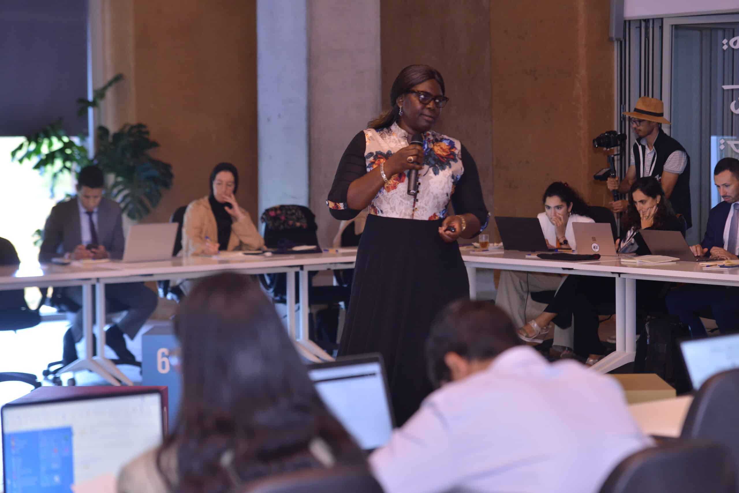 ILO staff member Seynabou Diouf is standing in front of a group of people and leading a workshop in Morocco.